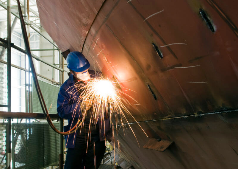 man welding ship