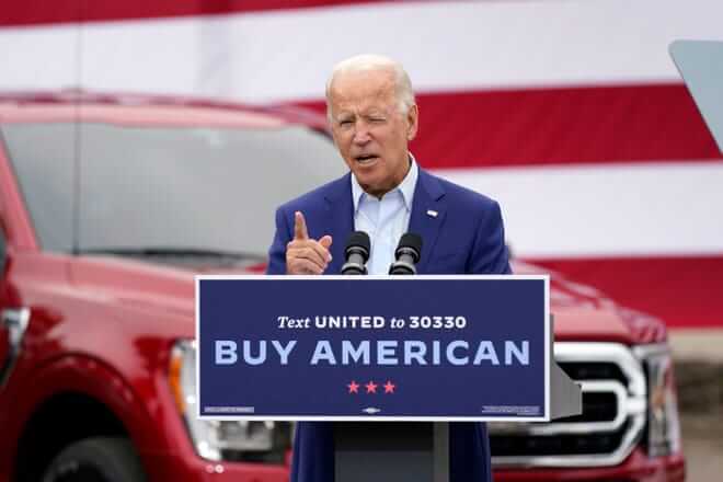 Joe Biden speaking at a podium outside