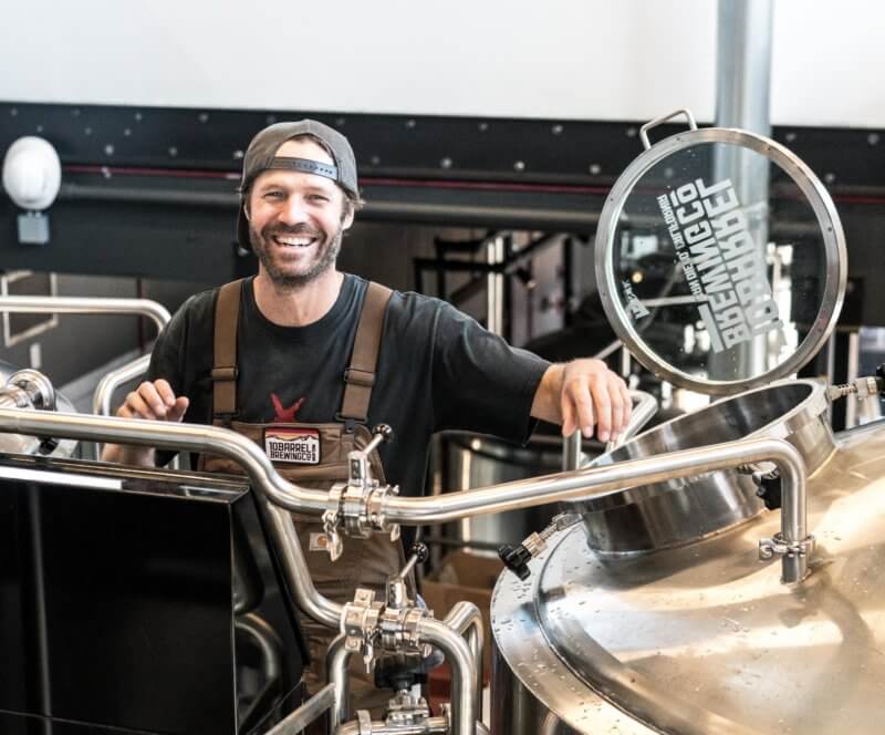 Smiling brewer in a brewery
